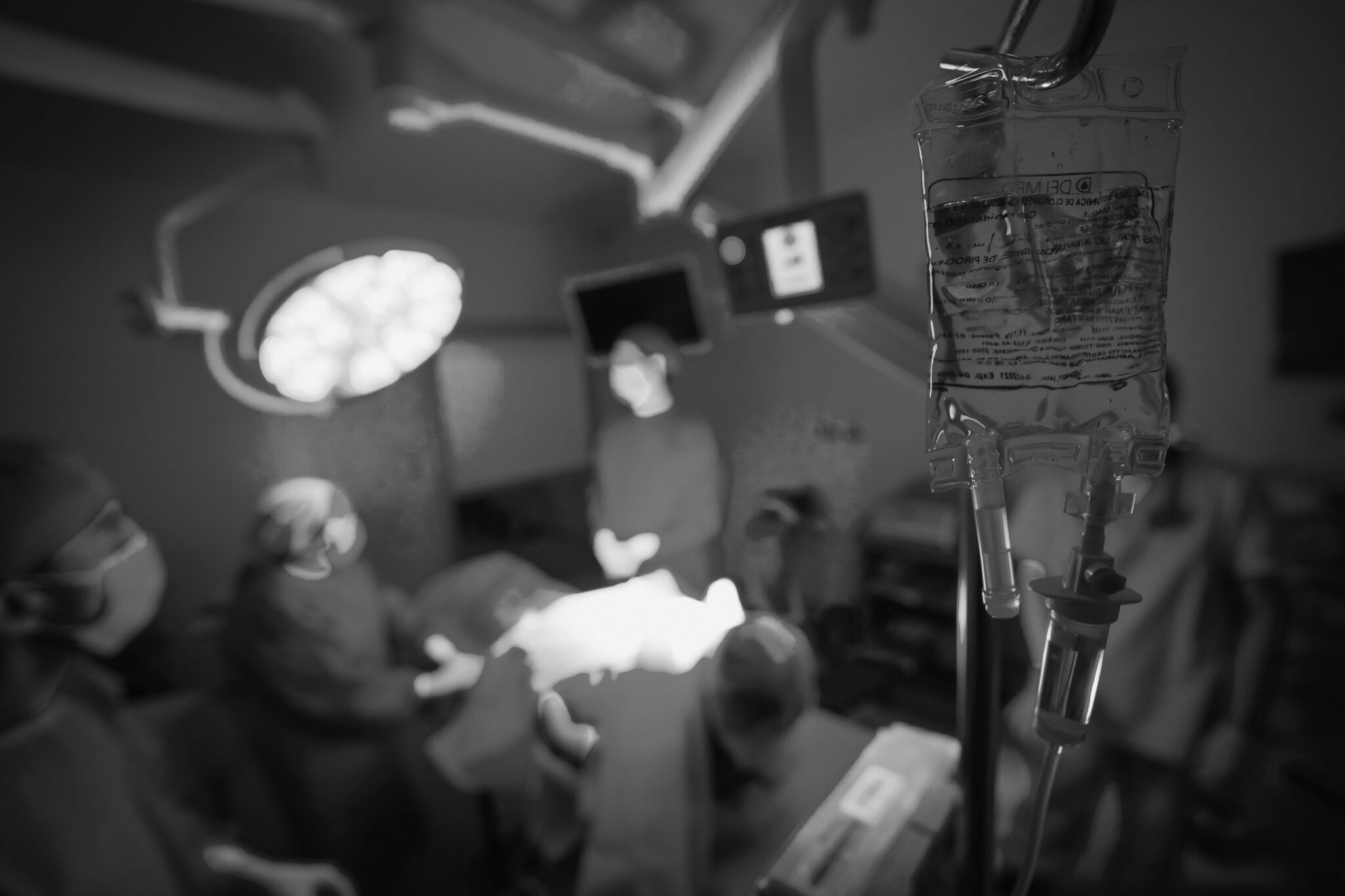 photo of an operating room taken with wide angle lens, rendered in black and white